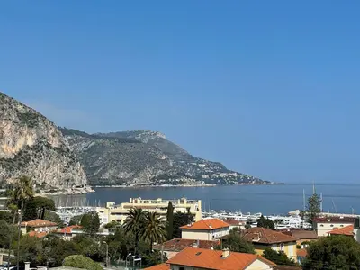 a view of a city and the water and mountains at Studio vue mer in Beaulieu-sur-Mer