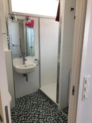 a small bathroom with a sink and a shower at Studio vue mer in Beaulieu-sur-Mer