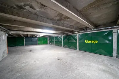 an empty parking garage with a green wall at Studio de la plage - Mer, Terrasse et garage in Cagnes-sur-Mer