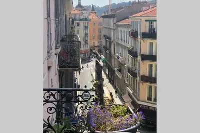 a small bedroom with a bed and a fan at Appartement 3 pièces ultra centre nice-ville in Nice