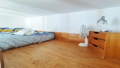 a room with a bunk bed and a desk and a ladder at Appartement 3 pièces ultra centre nice-ville in Nice