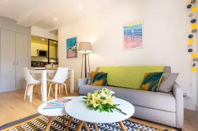 a living room with a couch and a table at JJ8 - MAGNIFIQUE 3PIECES, ENTIEREMENT RENOVE, CLIM, VIEUX-NICE in Nice