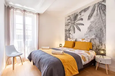 a bedroom with a large bed with a yellow blanket at JJ8 - MAGNIFIQUE 3PIECES, ENTIEREMENT RENOVE, CLIM, VIEUX-NICE in Nice