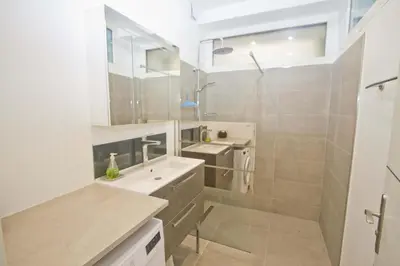 a white bathroom with a sink and a shower at Florida Sea Front in Nice