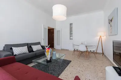 a living room with a red couch and a table at FEEL HOME - ASSALIT in Nice