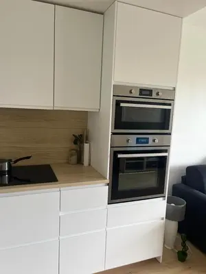 a kitchen with white cabinets and a stove top oven at 3 Piéces confort climatisé vue mer, 4 personnes à Saint-Jean Cap Ferrat à proximité de monaco et menton in Saint-Jean-Cap-Ferrat