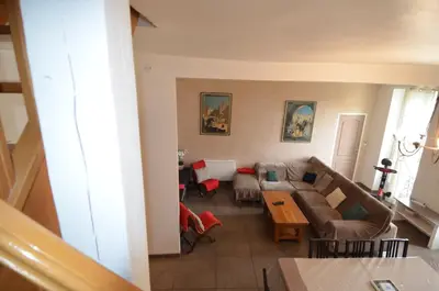 a living room with a couch and a table at DUPLEX BORRIGLIONE - Spacieux appartement pour 6 personnes au pied du tram in Nice