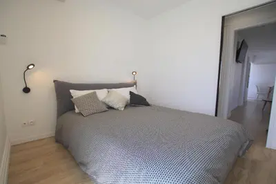 a bedroom with a bed with pillows on it at La terrasse de Carras in Nice