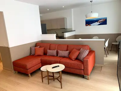 a living room with a red couch and a table at Share Inn Appartements in Nice
