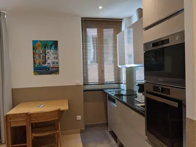 a small kitchen with a table and a microwave at Share Inn Appartements in Nice