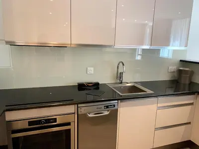 a kitchen with white cabinets and a sink at Share Inn Appartements in Nice