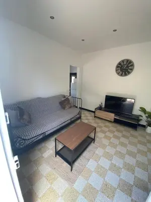 a living room with a couch and a table at Maisonnette Cagnes in Cagnes-sur-Mer