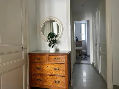 a dresser with a plant on top of it in a hallway at Stunning flat by the beach, Carre d'or-Negresco in Nice