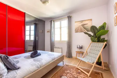 a room with a bed and a chair in it at Providence - ELEGANT F3, VUE INCROYABLE, BALCON,ASCENSEUR, WIFI in Nice