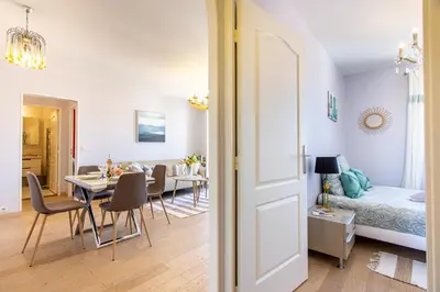 a dining room and living room with a dining table at Providence - ELEGANT F3, VUE INCROYABLE, BALCON,ASCENSEUR, WIFI in Nice