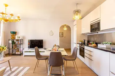 a kitchen and dining room with a table and chairs at Providence - ELEGANT F3, VUE INCROYABLE, BALCON,ASCENSEUR, WIFI in Nice