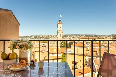 a table with a bowl of fruit on a balcony at Providence - ELEGANT F3, VUE INCROYABLE, BALCON,ASCENSEUR, WIFI in Nice