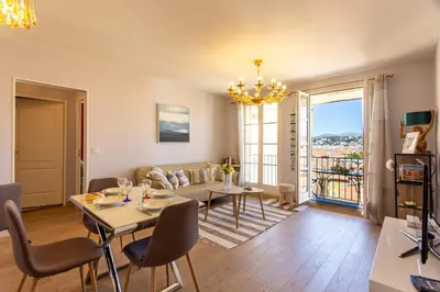 a dining room and living room with a table and chairs at Providence - ELEGANT F3, VUE INCROYABLE, BALCON,ASCENSEUR, WIFI in Nice