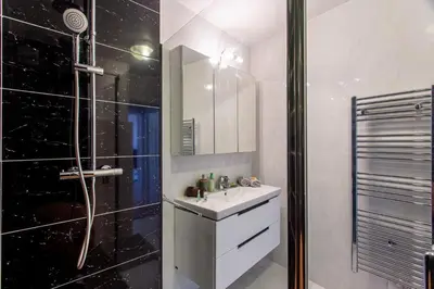 a white bathroom with a sink and a shower at Providence - ELEGANT F3, VUE INCROYABLE, BALCON,ASCENSEUR, WIFI in Nice