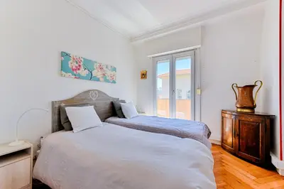 a bedroom with a large bed and a window at La terrasse de Rossini in Nice