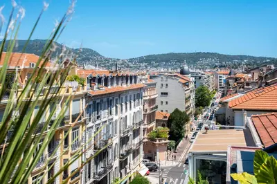 a view of a city street with buildings at La terrasse de Rossini in Nice