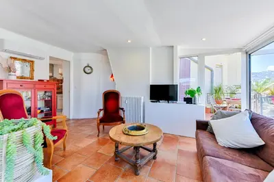 a living room with a couch and a table at La terrasse de Rossini in Nice