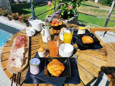 a wooden table with plates of food and drinks on it at Escondida in Nice