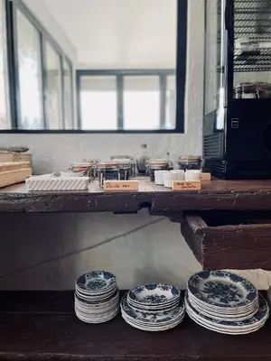 a table with blue and white plates on it at Escondida in Nice