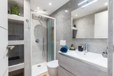 a bathroom with a shower and a sink and a toilet at Luxury 3 Bdr Garden & Parking - Angels' Garden in Nice