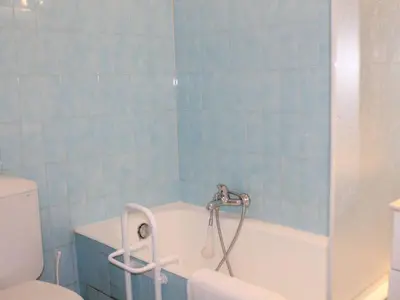 a blue tiled bathroom with a tub and a toilet at Studio Cosy avec Terrasse et Parking, à 30m de la Mer, Cagnes-sur-Mer - FR-1-252A-56 in Cagnes-sur-Mer