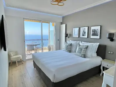 a bedroom with a large bed and a balcony at MyBlueVista LUXURY PANORAMIC SEA VIEW APARTMENTS CAP D AIL NEAR MONACO in Cap d'Ail