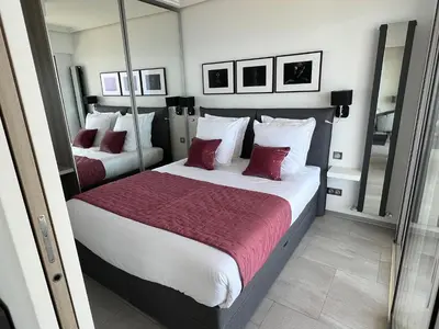 a bedroom with two beds with red and white pillows at MyBlueVista LUXURY PANORAMIC SEA VIEW APARTMENTS CAP D AIL NEAR MONACO in Cap d'Ail