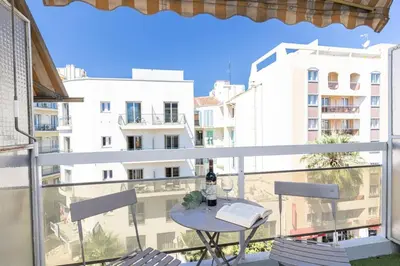 a table on a balcony with a view of a building at MY CASA - GROSSO 4 - Studio with Balcony - Near the Sea in Nice