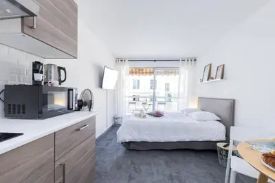 a white kitchen with a bed in a room at MY CASA - GROSSO 4 - Studio with Balcony - Near the Sea in Nice