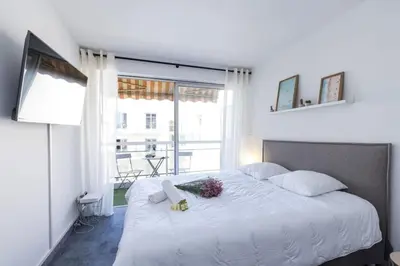 a bedroom with a large white bed with a window at MY CASA - GROSSO 4 - Studio with Balcony - Near the Sea in Nice