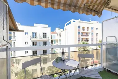 a balcony with a table and a view of a building at MY CASA - GROSSO 4 - Studio with Balcony - Near the Sea in Nice