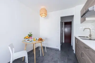 a kitchen with a table with a bowl of fruit on it at MY CASA - GROSSO 4 - Studio with Balcony - Near the Sea in Nice