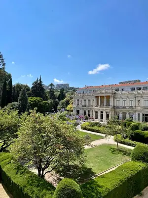 a large building with a garden in front of it at Air-conditioned apartment with garage near the sea in Nice