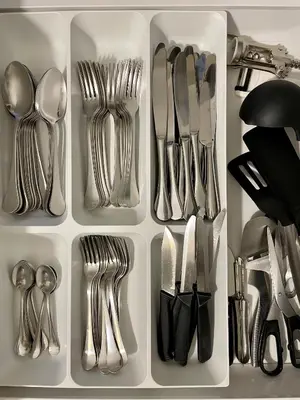a drawer filled with silver utensils and forks and spoons at Air-conditioned apartment with garage near the sea in Nice
