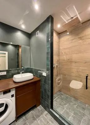 a bathroom with a sink and a washing machine at Air-conditioned apartment with garage near the sea in Nice
