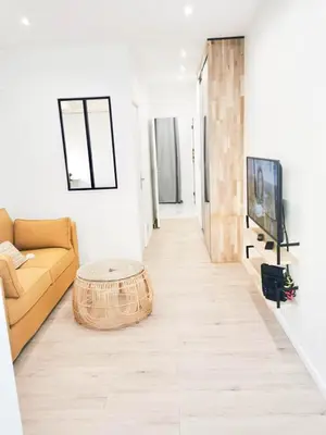 a living room with a couch and a table at Halévy Résidence in Nice