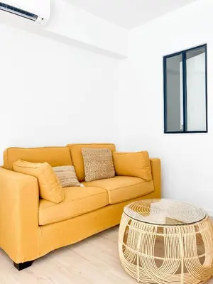 a living room with a yellow couch and a coffee table at Halévy Résidence in Nice