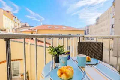 a table with two plates of fruit on a balcony at SUEDE 3 AP4209 By Riviera Holiday Homes in Nice