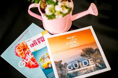 a table with a cup of popcorn and a magazine at SUEDE 3 AP4209 By Riviera Holiday Homes in Nice
