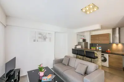 a living room with a couch and a table at SUEDE 3 AP4209 By Riviera Holiday Homes in Nice