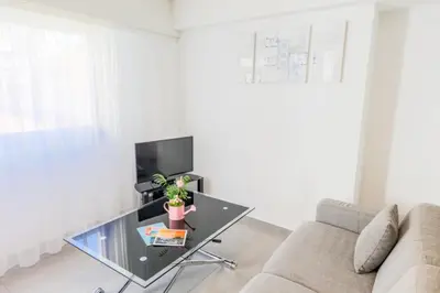 a living room with a glass table and a couch at SUEDE 3 AP4209 By Riviera Holiday Homes in Nice