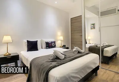 a bedroom with two beds with towels on them at Coeur Vieux Nice - Place Rossetti in Nice