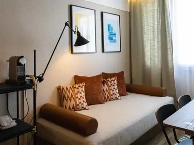a hotel room with a bed and a table at Novotel Suites Nice Airport in Nice