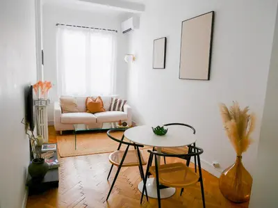 a living room with a table and a couch at Ker Riviera in Nice