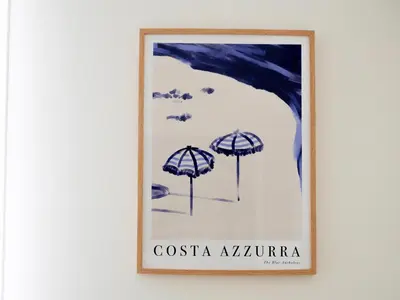 a framed painting of umbrellas on a wall at Ker Riviera in Nice